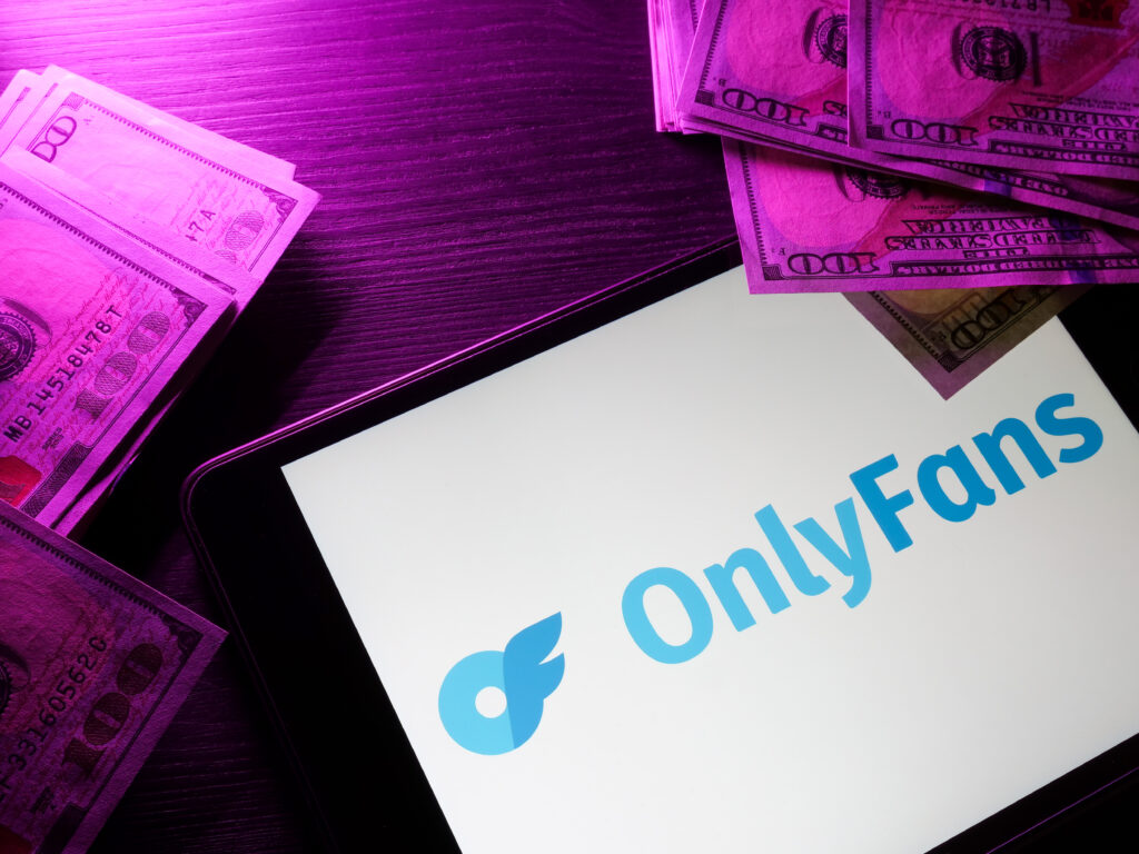 kyiv, ukraine may 4, 2022. tablet with onlyfans logo and money.